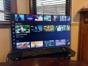 a flat screen tv sitting on top of a table at Amazing Entire Home in WOLVERHAMPTON in Wolverhampton +14 photos