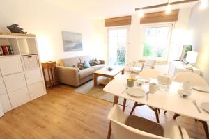 a living room with a table and a couch at MeerGlück in Langeoog