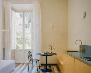 a kitchen and living room with a table and chairs at Palazzina Maresa in Florence