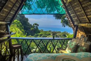 a view from a room with a view of the ocean at Finca Exótica in Carate