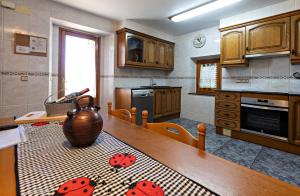 a kitchen with a table with lady bugs on it at Cal Fortic, Navès in Navés