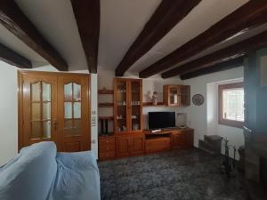 a bedroom with a bed and a television in it at Cal Fortic, Navès in Navés