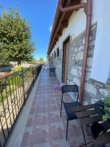 a patio with benches and a fence on a building at B&B Pozzo Innamorato in Montenero di Bisaccia