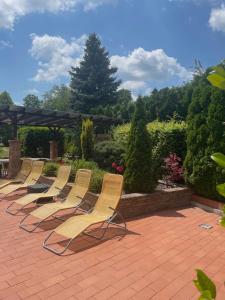 a row of chairs sitting on a patio at Relax Holiday House in Balatonrendes +15 photos