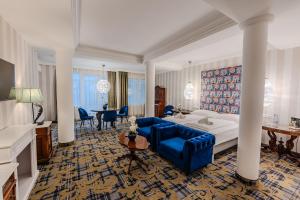 a large hotel room with a bed and a table at Pannonia 1893 Prémium in Sopron