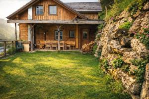 a wooden house with a table in front of it at Chalet Steiermark in Pusterwald