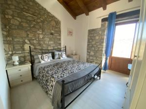 a bedroom with a bed and a stone wall at B&B Pozzo Innamorato in Montenero di Bisaccia +35 photos