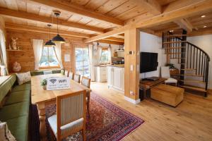 a living room with a couch a table and a tv at Chalet Steiermark in Pusterwald