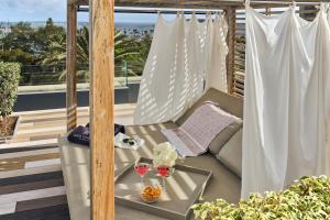 a balcony with a table and two glasses of wine at Santa Catalina, a Royal Hideaway Hotel - Gran Lujo in Las Palmas de Gran Canaria