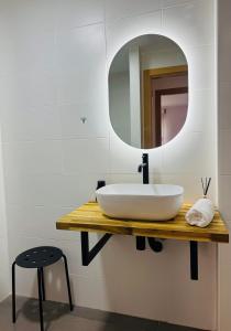 a bathroom with a white sink and a mirror at El Sueño De Albarracín IV in Albarracín +6 photos