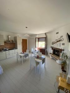 a living room with tables and chairs and a fireplace at B&B Pozzo Innamorato in Montenero di Bisaccia