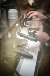 a person is working on a table with a machine at Mañana Mañana in Antwerp
