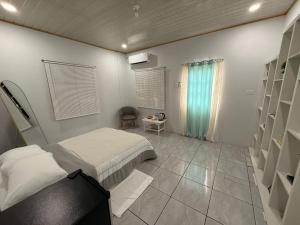 a bedroom with a bed and a chair in it at Rest a While in San Juan