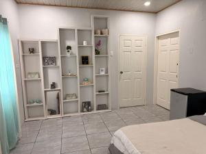 a bedroom with white shelves and a bed at Rest a While in San Juan +1 photo