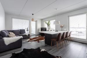 a living room with a couch and a table at Luxurious Penthouse - Hot Tub & Sauna in Tampere