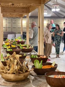 a buffet with many bowls of food on a table at ULORA Luxury Camp in Wadi Rum +76 photos