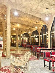 a room with tables and chairs and tablesearcher at ULORA Luxury Camp in Wadi Rum