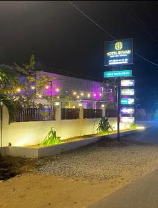 a sign for a fast food restaurant at night at Hotel Ruwan in Kataragama +7 photos