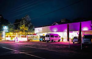 a white van parked in front of a building at night at Hotel Ruwan in Kataragama