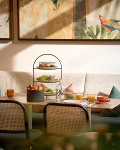 a table with a plate of food on it at Hotel Karol in Vienna