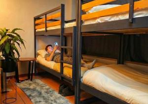 a person laying on a bunk bed in a room at Hostel Cangas Backpackers in Cangas de Morrazo