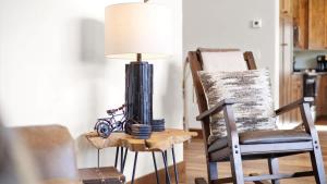 a lamp sitting on a table next to a chair at Paradise View in Red Lodge