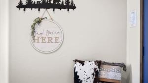 a mirror hanging on a wall next to a pillow at Paradise View in Red Lodge