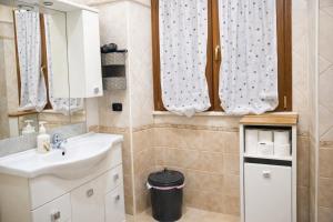 a bathroom with a sink and a mirror at Golden Stay Rome - Golden Room - Close to Metro C in Tor Vergata