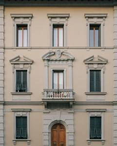 a building with a balcony and a clock on it at Palazzina Maresa in Florence