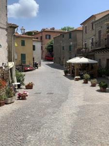 an empty street in a town with buildings and flowers at Casa Tirli in Tirli