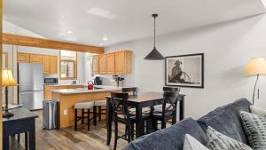a kitchen and living room with a couch and a table at Peaks & Par in Red Lodge