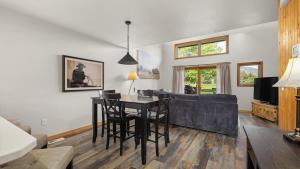 a living room with a table and a couch at Peaks & Par in Red Lodge +34 photos
