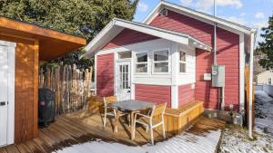 a tiny house with a table and chairs on a deck at Rio Ridge in Red Lodge