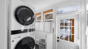 a laundry room with a washer and dryer next to a door at Rio Ridge in Red Lodge +25 photos