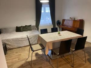 a room with a bed and a table and chairs at Rodinný dům se zahradou - Pardubice Svítkov in Pardubice