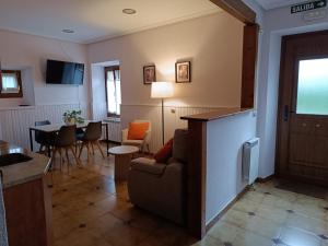 a living room with a couch and a table at TXARRENEA in Elizondo +17 photos