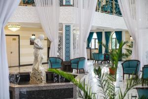 a lobby with a statue in the middle of a building at KHIVA RESIDENCE - Eastern Hotel in Khiva +128 photos