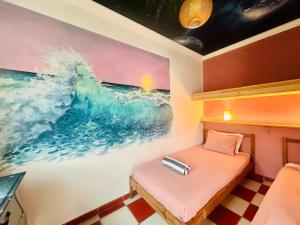 a room with a bed and a painting on the wall at Captain's Log House in Baleal