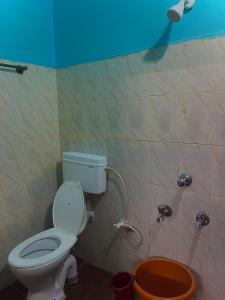 a bathroom with a toilet and a shower at Aarvi Residency in Māvalli