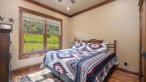 a bedroom with a bed and a window at Rock Creek Escape in Red Lodge