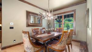 a dining room with a wooden table and chairs at Rock Creek Escape in Red Lodge +28 photos