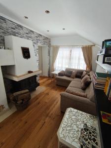 a living room with a couch and a fireplace at Land - Haus in Pusterwald