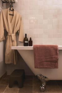 a bathroom with a bath tub and a towel at Maison d'hôtes La bien-Aimée in Montrevault