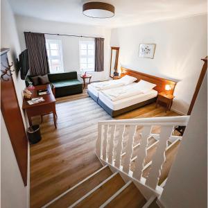 a hotel room with a bed and a staircase at Burg Warberg in Warberg +43 photos