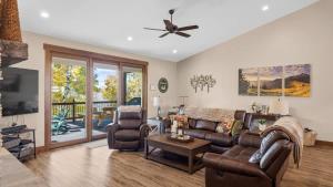 a living room with a couch and chairs and a ceiling fan at Willow Creek Hideaway in Red Lodge