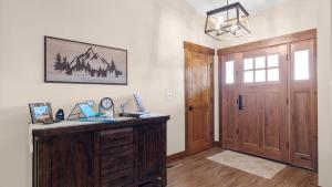 a room with a wooden desk and a wooden door at Willow Creek Hideaway in Red Lodge