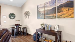 a room with a bed and a table on a wall at Willow Creek Hideaway in Red Lodge