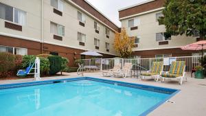 a swimming pool with chairs and a playground and a building at Best Western Sky Valley Inn in Monroe