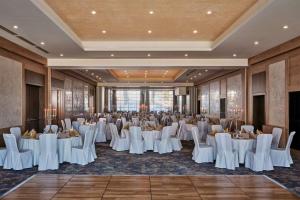 a banquet hall with white tables and chairs at Radisson Blu Hotel & Residences Zakopane in Zakopane +249 photos