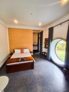 a bedroom with a bed and a large window at The Birdy Retreat Ella in Ella